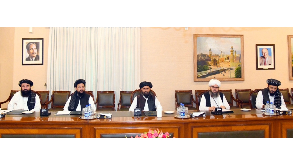 Mullah Abdul Ghani Baradar (C) the leader of the Taliban delegation along with other members is seen during a meeting with Pakistan's Foreign Minister Shah Mahmood Qureshi (not pictured) at the Minist