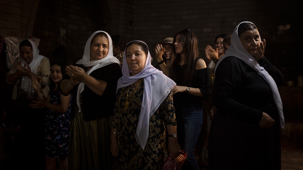 In this Sept. 12, 2019 photo, Yazidi women visit Lalish, the holiest Yazidi shrine, in Iraq's Dohuk province, in northern Iraq. During a week-long assault by Islamic State militants in 2014, they kill