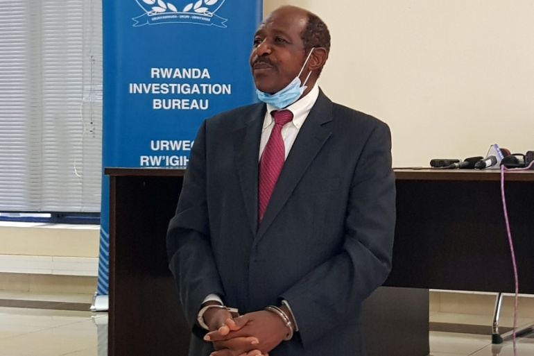 Paul Rusesabagina, the man who was hailed a hero in a Hollywood movie about the country's 1994 genocide is detained and paraded in front of media in handcuffs at the headquarters of Rwanda Investigation Bureau in Kigali, Rwanda August 31, 2020 [Clement Uwiringiyimana/Reuters]