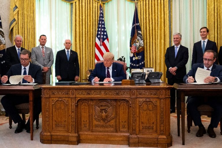 President Donald Trump participates in a signing ceremony with Serbian President Aleksandar Vucic, left, and Kosovar Prime Minister Avdullah Hoti, in the Oval Office of the White House,