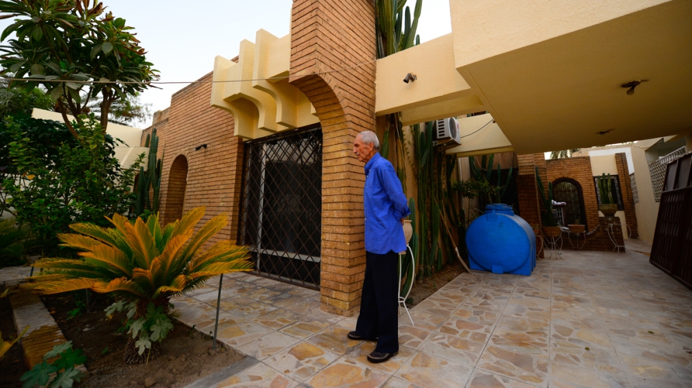 Waleed Ahmed looks out on his garden at his 1970s home in Baghdad’s Harthiya neighborhood. Few of the new buildings include gardens, which are important to absorb the heat during sweltering summer day