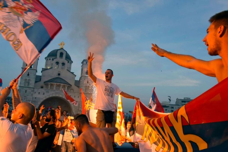 Opposition supporters celebrate after the parliamentary elections in front of the Serbian Orthodox Church of Christ''s Resurrection in Podgorica, Montenegro, Monday, Aug. 31, 2020.