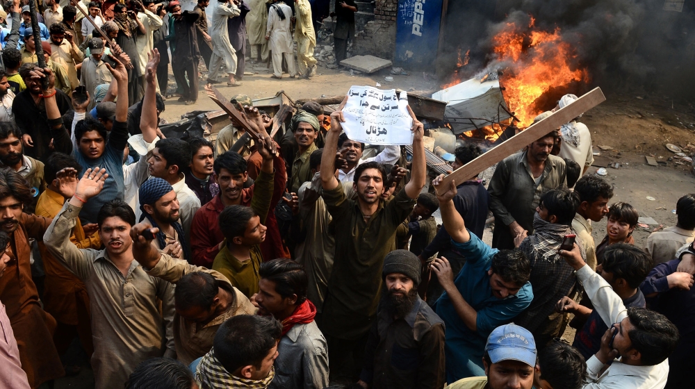 Angry Pakistani demonstrators shout slogans during a protest over alleged blasphemous remarks by a Christian in a Christian neighborhood in Badami Bagh area of Lahore on March 9, 2013. Thousands of an