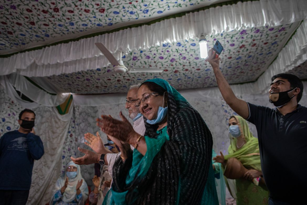 Kashmiri couple, center, clap as they celebrate henna ceremony of their son''s wedding Haseeb Mushtaq, on the outskirts of Srinagar, Indian controlled Kashmir, Sunday, Sept. 13, 2020. The coronavirus p