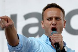 In this file photo taken on Saturday, July 20, 2019, Russian opposition activist Alexei Navalny gestures while speaking to a crowd during a political protest in Moscow, Russia. Russian doctors treatin