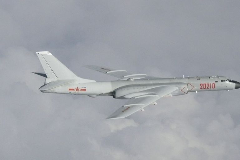 China H-6 bomber flying in the clouds over the East China Sea.