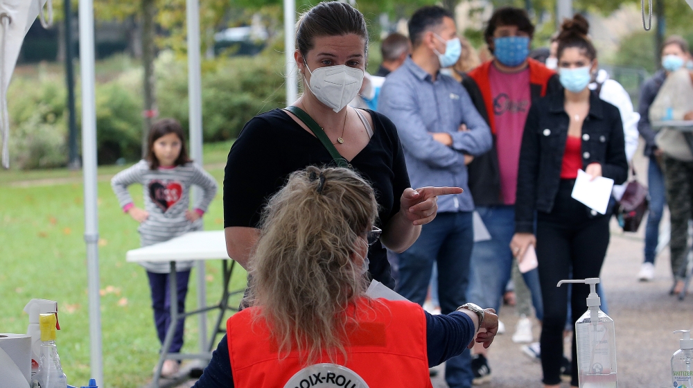 People arrive at a coronavirus testing centre in Bayonne, southwestern France, Tuesday, Sept. 22, 2020. France is reporting several thousand virus cases a day and more than 80 weekly cases per 100,000