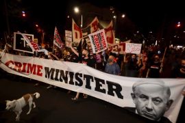Israeli protesters hold signs and chant slogans during a demonstration against Israeli Prime Minister Benjamin Netanyahu In Tel Aviv, Israel, Thursday, Aug. 27, 2020