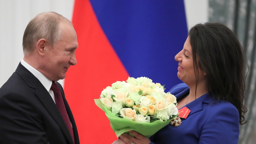Russian President Putin and editor-in-chief of broadcaster RT Simonyan attend an awarding ceremony in Moscow