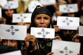 FILE PHOTO: Rohingya refugee women hold placards as they take part in a protest at the Kutupalong refugee camp to mark the one-year anniversary of their exodus in Cox''s Bazar