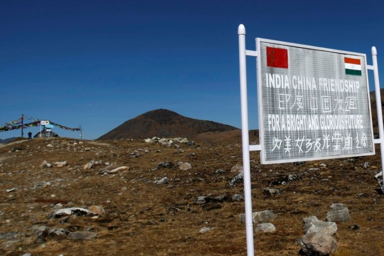 A signboard is seen from the Indian side of the Indo-China border at Bumla, in the northeastern Indian state of Arunachal Pradesh, November 11, 2009. REUTERS/Adnan Abidi/File Photo