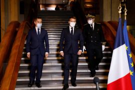 French President Emmanuel Macron arrives to deliver a speech next to Interior Minister Gerald Darmanin and Seine-Saint-Denis prefect Georges-Francois Leclerc in Bobigny, near Paris on October 20, 2020 [Ludovic Marin/Pool via Reuters]