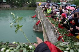 Bosnian Muslims toss 3,000 roses into the Drina River, each representing people killed in the 1992-95 war, in the eastern Bosnian town of Višegrad, on May 26, 2012 [File: AP/Amel Emric]
