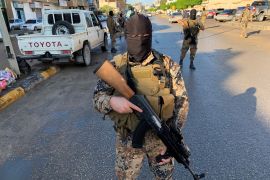 A member of the Libyan security forces holds a rifle in Misrata