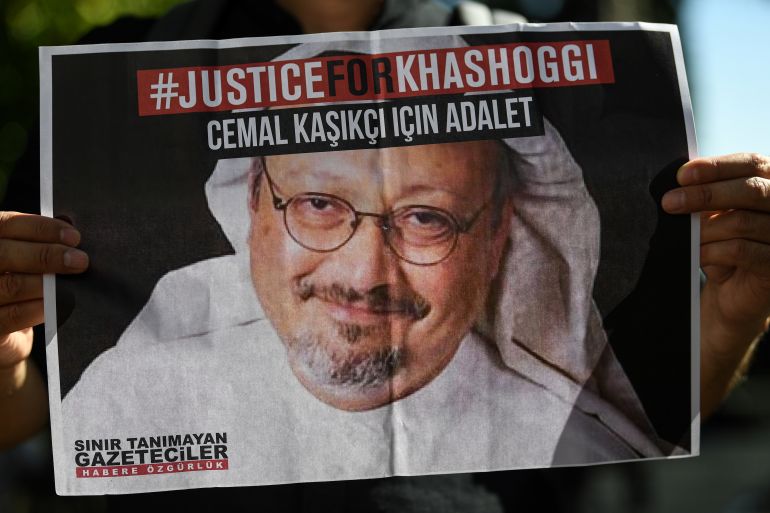 Friends of murdered Saudi journalist Jamal Khashoggi hold posters bearing his picture