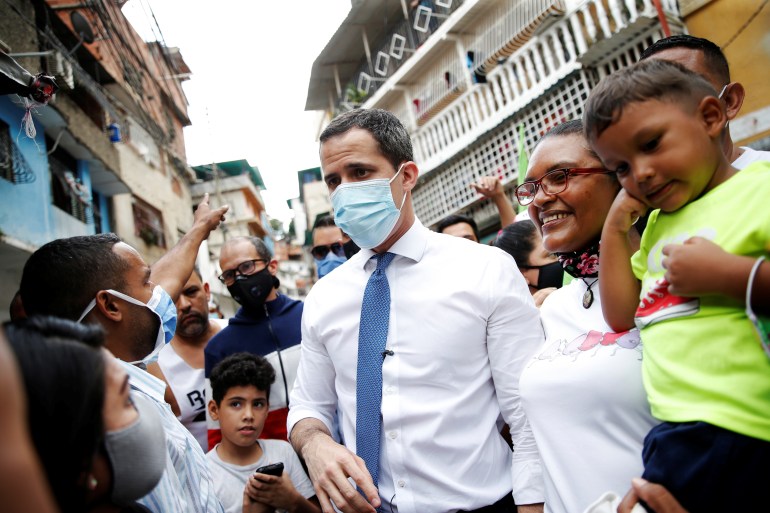 Venezuela's opposition leader Juan Guaido greets supporters in a low income neighborhood