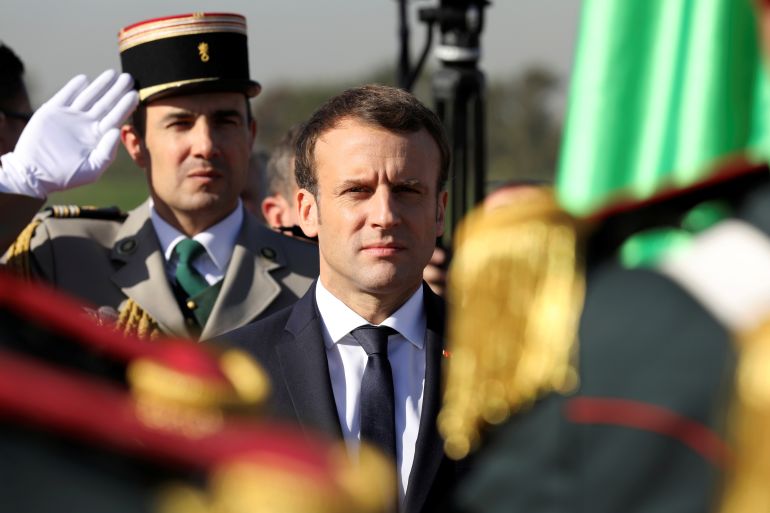 French President Emmanuel Macron reviews troops at Algiers Airport