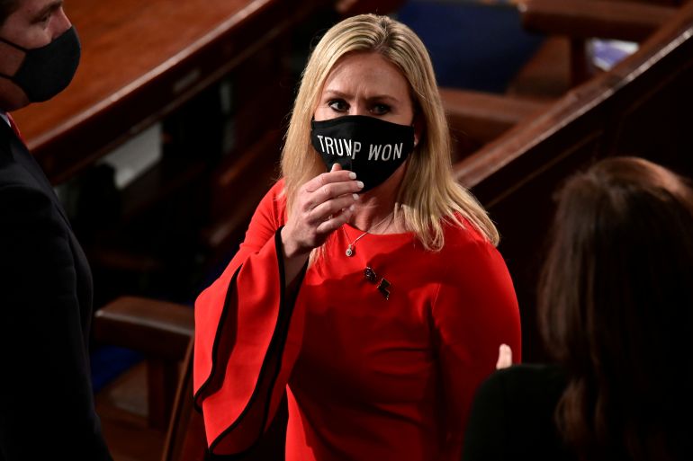 U.S. Rep. Marjorie Taylor Greene (R-GA) wears a "Trump Won" face mask as she arrives on the floor of the House to take her oath of office .