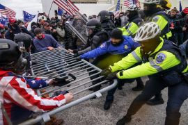 Trump supporters try to break through a police barrier, Jan 6, 2021, at the Capitol in Washington, DC [File: John Minchillo/AP Photo]