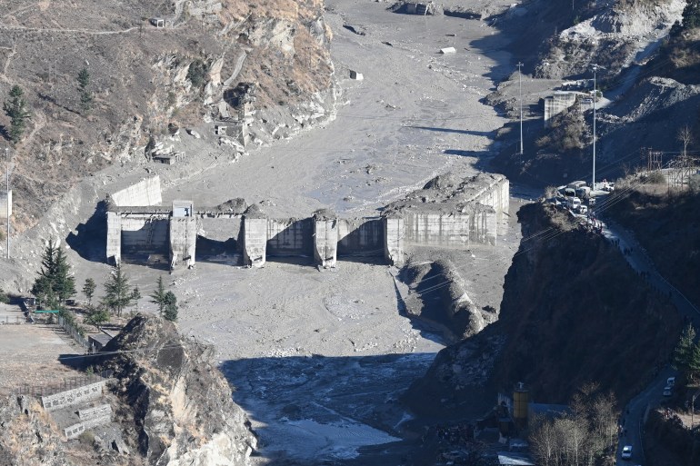 A general view shows the remains of a dam along a river in Tapovan of Chamoli district on February 8, 2021 damaged after a flash flood thought to have been caused when a glacier broke off 
