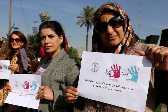 Iraqi women demonstrate at a vigil condemning violence against women