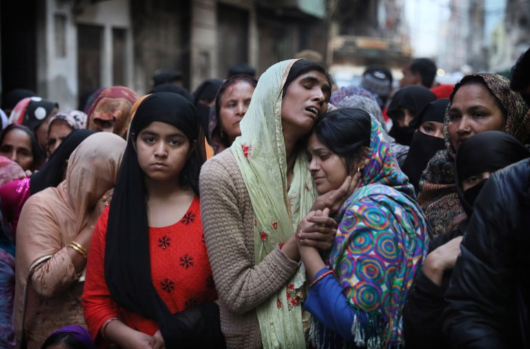 File photo of relatives mourn the death of a man killed in Delhi violence