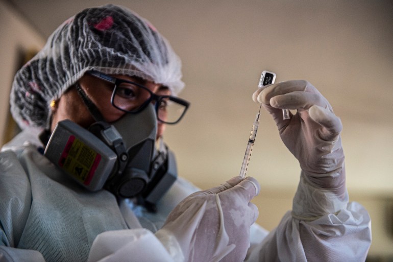 A health worker prepares a vaccine shot