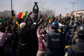 Demonstrators shout slogans in front of riot policemen during a protest against the arrest of opposition leader and former presidential candidate Ousmane Sonko, Senegal, Monday, March 8, 2021 [Leo Correa/AP Photo]
