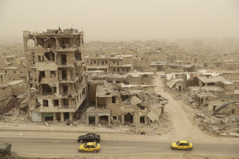 A picture taken during a sandstorm shows destruction in the once rebel-held Karm al-Jabal neighbourhood in the northern city of Aleppo on March 10, 2017