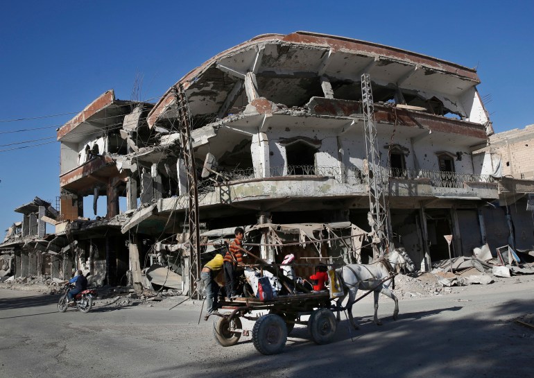 the remains of buildings line a street that was damaged last summer during fighting between U.S.-backed Syrian Democratic Forces fighters and Islamic State militants, in Raqqa, Syria.
