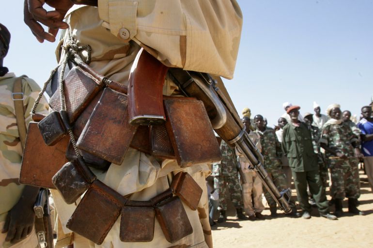 In this photo taken Sunday, November 7, 2010, a soldier of the joint Sudanese-Chadian border patrol forces attends a meeting with Sudanese government officials near Seleah in West Darfur, Sudan.