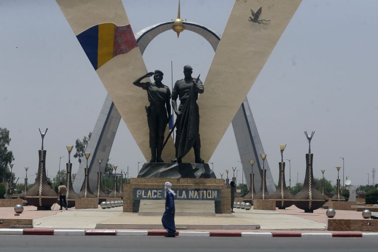 A man walks past "Place de Le Nation" (Monument of independence) park in N'Djamena, Chad, Monday, April 26, 2021. Chad's military transitional government said Sunday it will not negotiate with the rebels blamed for killing the country's president of three decades, raising the specter that the armed fighters might press ahead with their threats to attack the capital.