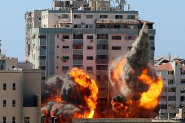 An explosion is seen near a tower housing AP, Al Jazeera offices during Israeli missile strikes in Gaza city,