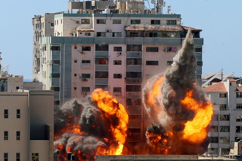 An explosion is seen near a tower housing AP, Al Jazeera offices during Israeli missile strikes in Gaza city,