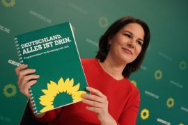 Annalene Baerbock, co-leader of the German Greens Party, holds up a description of the party&#39;s policy program at a livestreamed, digital press conference ahead of Germany&#39;s federal elections scheduled for September on March 19, 2021 in Berlin, Germany [Sean Gallup/Getty Images]