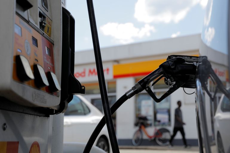 A gas pump is seen in a car at a Shell gas station,