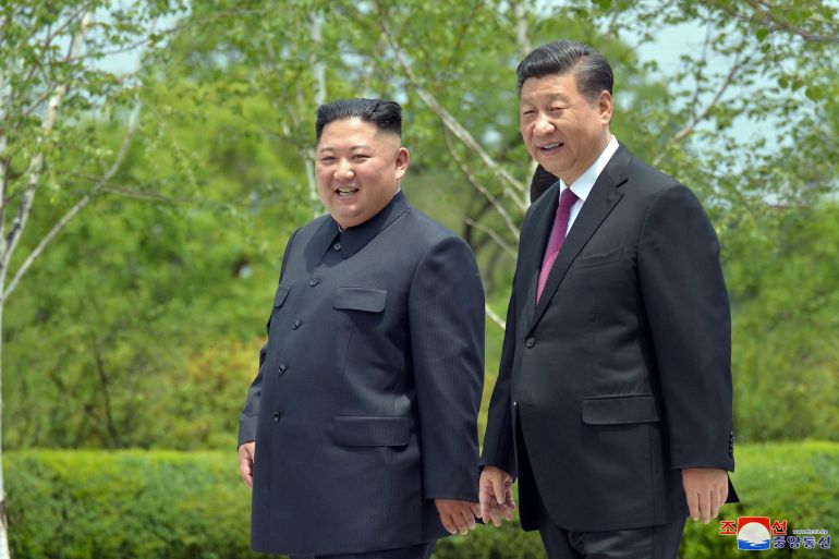 Chinese President Xi Jinping and North Korean leader Kim Jong Un walk during Xi's visit in Pyongyang, North Korea