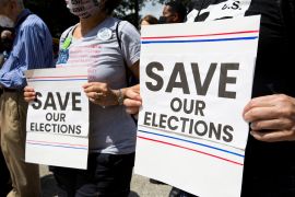 Protesters hold signs reading 'Save our Elections' in support of voting rights in Texas