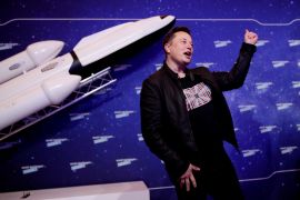 SpaceX owner and Tesla CEO Elon Musk gestures after arriving on the red carpet for the Axel Springer award.