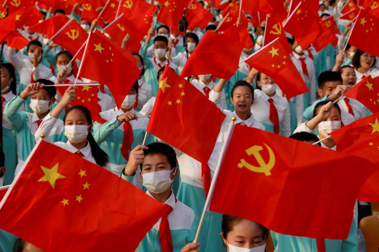 Performers with flags of the communist party and the People's Republic of China