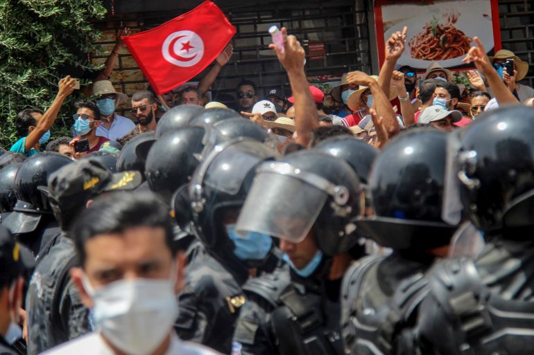 Protesters face Tunisian police officers during a demonstration in Tunis, Tunisia