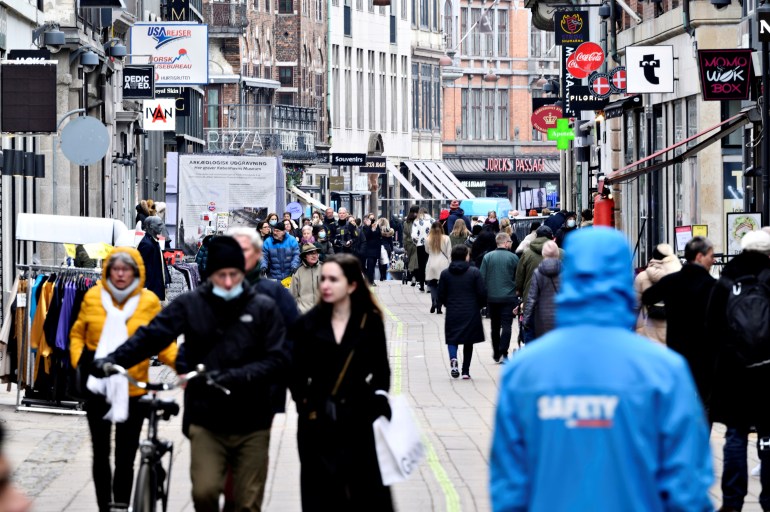People walk on a street as stores reopen amid the coronavirus disease