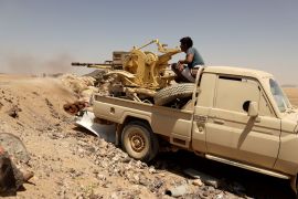 FILE PHOTO: A Yemeni government fighter fires a vehicle-mounted weapon at a frontline position during fighting against Houthi fighters in Marib, Yemen March 28, 2021.
