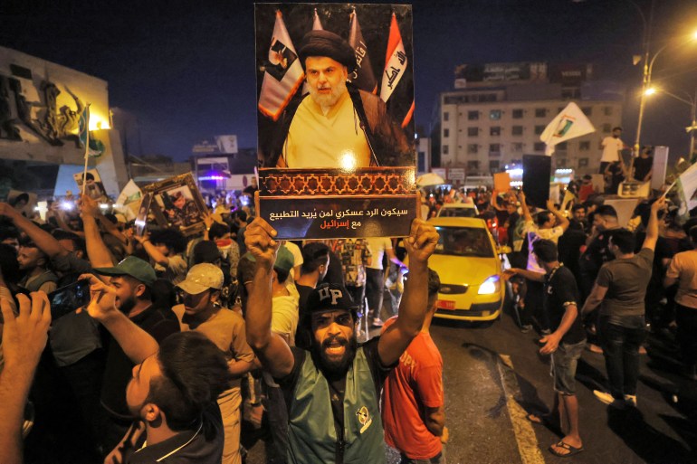Supporters of Iraqi Shiite cleric Moqtada al-Sadr celebrate in Baghdad's Tahrir square