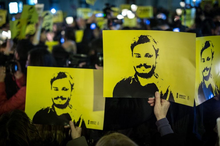 People during a march and torchlight procession in memory of the Italian researcher Giulio Regeni
