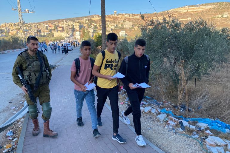 Palestinian schoolkids are forced to walk along a highway used by settlers to get to their school in Luban Ash-Sharqiya, in Nablus, northern occupied West