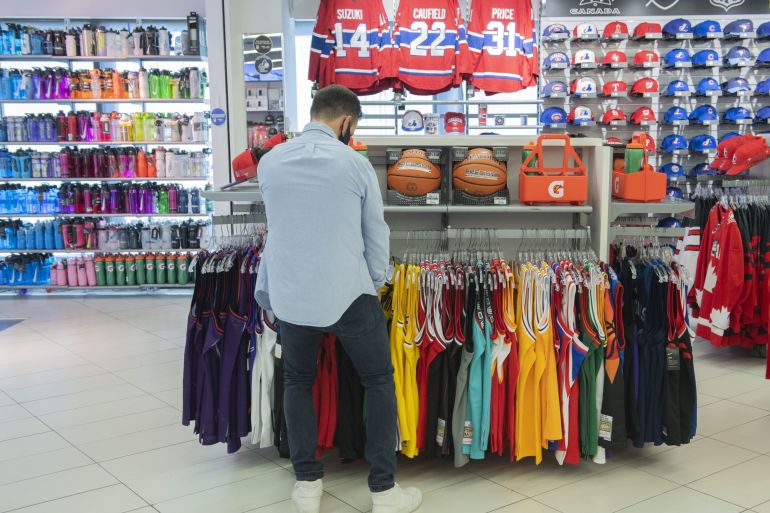 A shopper browses clothing at a Sports Experts store on Sainte-Catherine street in Montreal, Quebec, Canada