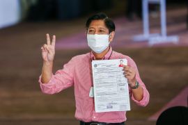 Son of former dictator Ferdinand Marcos, Ferdinand &#39;Bongbong&#39; Marcos Jr, gestures after filing his candidacy for the country&#39;s 2022 presidential race, at Sofitel Harbor Garden Tent in Pasay on October 6, 2021 [File: Rouelle Umali/AFP]