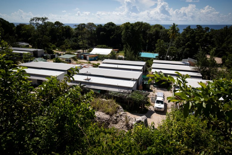 A view of the Nibok immigration centre in Nauru. There are long blocks of buildings in a clearing surrounded by trees