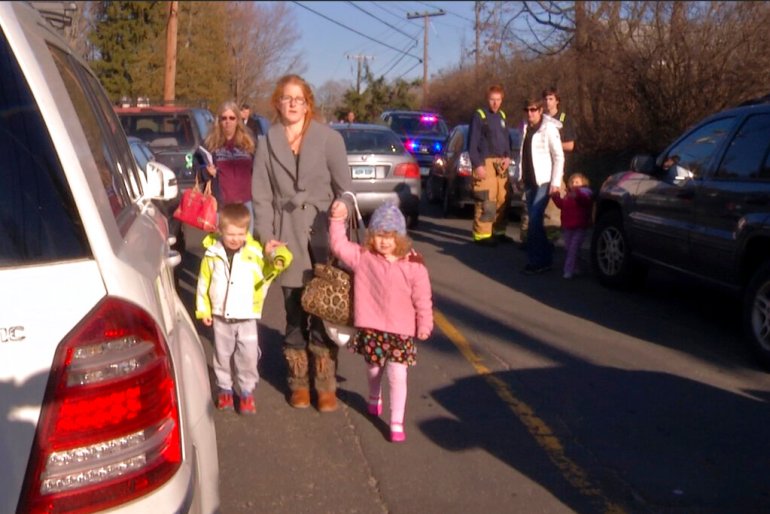 After being reunited with family outside Sandy Hook Elementary School in Newtown, Connecticut, people leave the area.